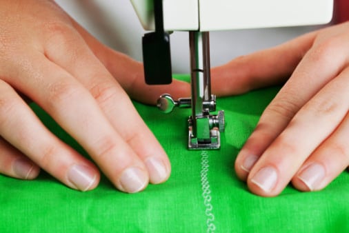 Stitching green fabric with a sewing machine