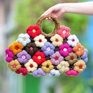 Bolsa bordado de uma mão de Crochê com flores coloridas.